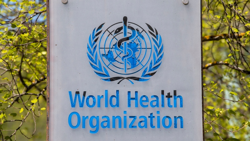 FILE - The logo and building of the World Health Organization (WHO) headquarters in Geneva, Switzerland, 15 April 2020. The World Health Organization says on Thursday, Jan. 6, 2022 a record 9.5 million cases of COVID-19 were tallied around the world over the last week, noting a 71% surge in the weekly count of infections amounting to a 'tsunami' as the new omicron variant sweeps worldwide. But there was a decrease in the number of new deaths recorded. (Martial Trezzini/Keystone via AP, file)