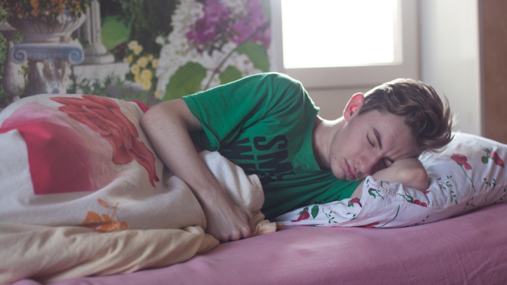 Pearson in a green t-shirt sleeping