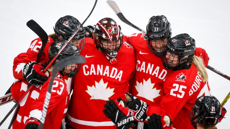 Canada's goalie Ann-Renee Desbiens, centre, celebrates with teammates after defeating Switzerland during third period semi-final IIHF Women's World Championship hockey action in Calgary, Alta., Monday, Aug. 30, 2021. THE CANADIAN PRESS/Jeff McIntosh 