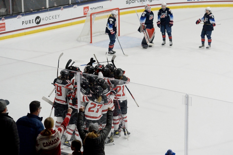 Members of Team Canada celebrate the game winning goal during the overtime period of a women's exhibition hockey game ahead of the Beijing Olympics, Friday, Dec. 17, 2021, in Maryland Heights, Mo. (AP Photo/Michael Thomas) 