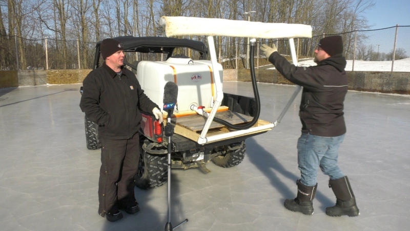 Brothers Daryn (left) and Tyler (right) Hicks demonstrate their ice surfacing machine, which is attached to the back of an ATV. (Peter Szperling/CTV News Ottawa)