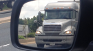 A transport truck is seen in a side view mirror - File Image (CTV News)