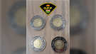 OPP say these counterfeit Toonies were found in Hawkesbury, Ont. on Tuesday, Jan. 11, 2022. (Handout/OPP)