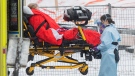 Paramedics transfer a person from an ambulance into a hospital in Montreal, Sunday, Jan. 9, 2022. THE CANADIAN PRESS/Graham Hughes