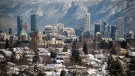 FILE - Snow-covered houses and the downtown skyline are seen with the north shore mountains in the distance after 21 centimetres of snow fell overnight, in Vancouver, on Thursday, December 30, 2021. THE CANADIAN PRESS/Darryl Dyck