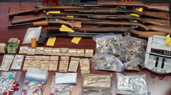 Firearms, drugs and cash seized by police on Nov. 19, 2021 is seen in this image released by Elgin County OPP.