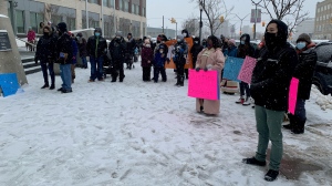 Dozens of people marched from Saskatoon Police Service headquarters to City Hall on Jan. 13 calling for charges to be laid against the person driving the vehicle in a crash that killed a nine-year-old girl. (Tyler Barrow/CTV Saskatoon)
