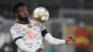 Bayern's Alphonso Davies controls the ball in the air during the German Supercup soccer match between Borussia Dortmund and Bayern Munich in Dortmund, Germany, on Aug. 17, 2021. (Martin Meissner / AP)