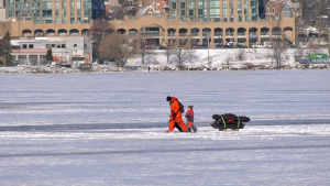 A man and child walk out onto the ice on Lake Simcoe in Barrie, Ont., on Fri., Jan. 14, 2022 (Steve Mansbridge/CTV News) 