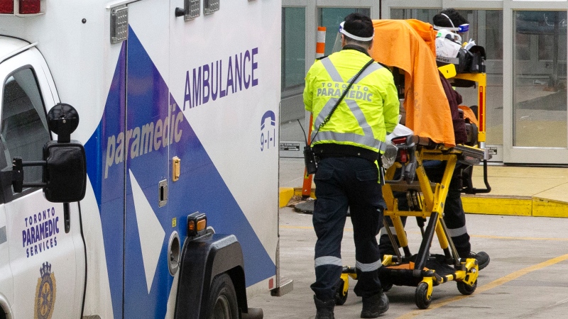 Paramedics wheel a patient into the emergency department of a Toronto Hospital on Wednesday, January 5, 2022.THE CANADIAN PRESS/Chris Young 