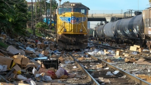Shredded boxes and packages are seen at a section of the Union Pacific train tracks in downtown Los Angeles Friday, Jan. 14, 2022. (AP Photo/Ringo H.W. Chiu)