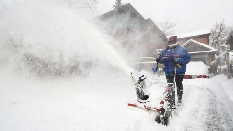 An Ontario resident shovels snow. (The Canadian Press)