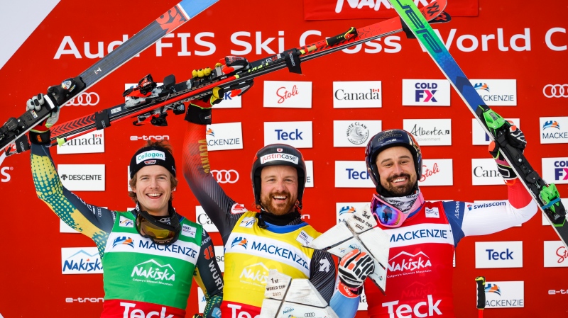 Canada's Kris Mahler, centre, celebrates his victory with second place finisher Germany's Florian Wilmsmann, left, and third place finisher Switzerland's Ryan Regez following the men's final at the World Cup ski cross event at Nakiska Ski Resort in Kananaskis, Alta., Saturday, Jan. 15, 2022.THE CANADIAN PRESS/Jeff McIntosh 