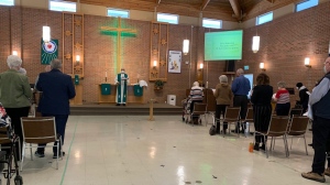 Pastor James Chimirri-Russell leads a service at Good Lutheran Church on Sunday. While some people gathered at a distance in-person, others are also able to watch from home. (KAYLYN WHIBBS/CTV News) 