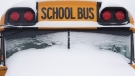 A school bus sits idle after winter conditions suspended the school transportation service in Toronto on Tuesday, February 16, 2021, on the first day of the return to in-school learning following a break due to COVID restrictions.THE CANADIAN PRESS/Chris Young 