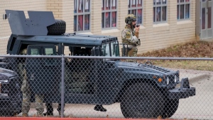 Law enforcement teams stage near Congregation Beth Israel while conducting SWAT operations in Colleyville, Texas on Saturday afternoon, Jan. 15, 2022. (Smiley N. Pool/The Dallas Morning News via AP) 