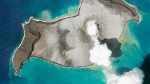 In this satellite photo taken by Planet Labs PBC, an island created by the underwater Hunga Tonga Hunga Ha'apai volcano is seen smoking on Jan. 7, 2022. (Planet Labs PBC via AP)