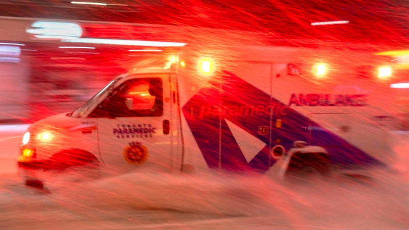 An ambulance races through a winter storm in Toronto on Monday January 17, 2022. THE CANADIAN PRESS/Frank Gunn 