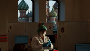 A medical worker prepares a shot of Russia's Sputnik Lite coronavirus vaccine at a vaccination centre in Red Square, Moscow, on Oct. 26, 2021. (Pavel Golovkin / AP) 