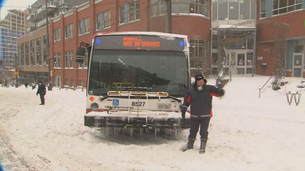 A TTC bus that became stuck in the snow along Queen Street East on Monday morning is shown.