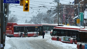 A Toronto commuter took this photo on Monday morning of multiple Toronto buses stuck in the snow on Queen Street West. (Javier Dávila/Twitter)