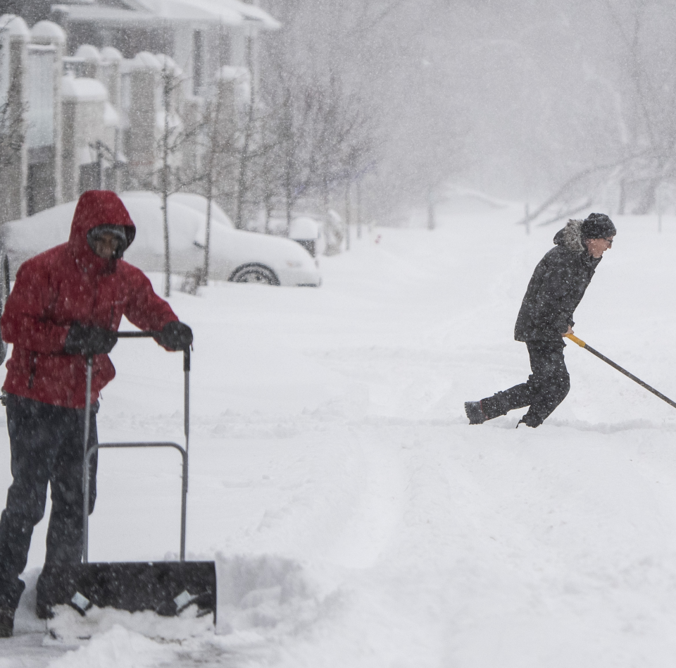 People work to clear their driveways in Ottawa