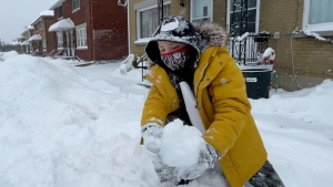 Clayton McGuire, 8, plays in the snow in front of his home in Ottawa. Jan. 17, 2022. (Peter Szperling/CTV News Ottawa)