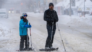 Snowshoers pause on a major road artery during a severe winter storm in Toronto on Monday January 17, 2022. THE CANADIAN PRESS/Frank Gunn 
