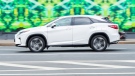 Side view of a white Lexus RX in motion on highway (Konstantin Grigorev | Dreamstime.com)