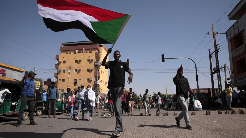 People march during a protest to denounce the October 2021 military coup, in Khartoum, Sudan, Sunday, Jan. 9, 2022. (AP Photo/Marwan Ali) 