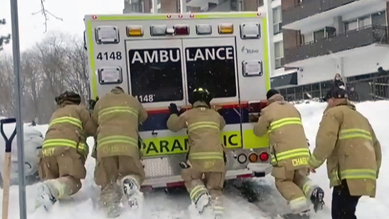 Ottawa firefighters push ambulance stuck on street