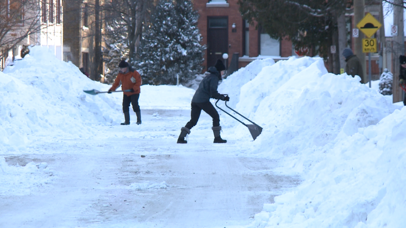 Ottawa residents shovel show after a blizzard dumped a record 47.8 cm of snow in Ottawa on Monday, Jan. 17, 2022. (Jim O'Grady/CTV News Ottawa)