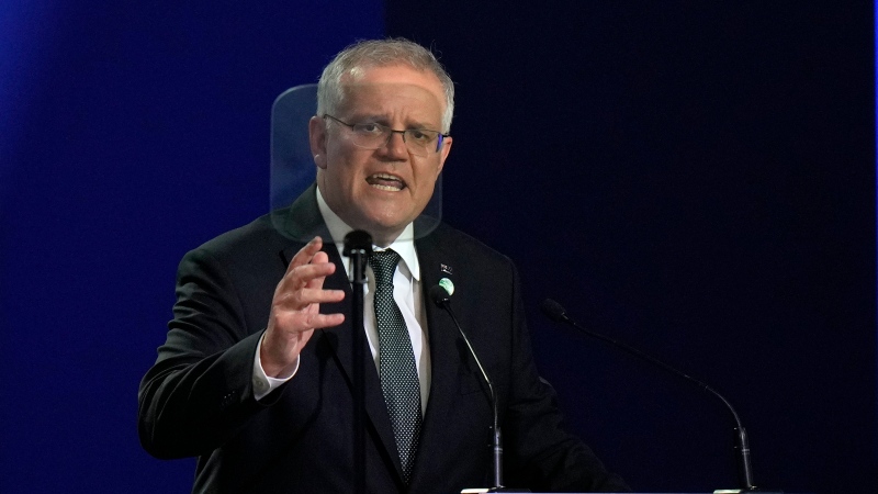 Australian Prime Minister Scott Morrison gestures as he makes a statement at the COP26 UN Climate Summit in Glasgow, Scotland, Monday, Nov. 1, 2021.(AP Photo/Alastair Grant, Pool) 