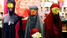 Islamic face-covering veils, burkini and clothes are displayed inside an exhibition hall at the France Muslim Annual Fair in Le Bourget, north of Paris, Saturday, April 15, 2017. (AP Photo/Francois Mori)