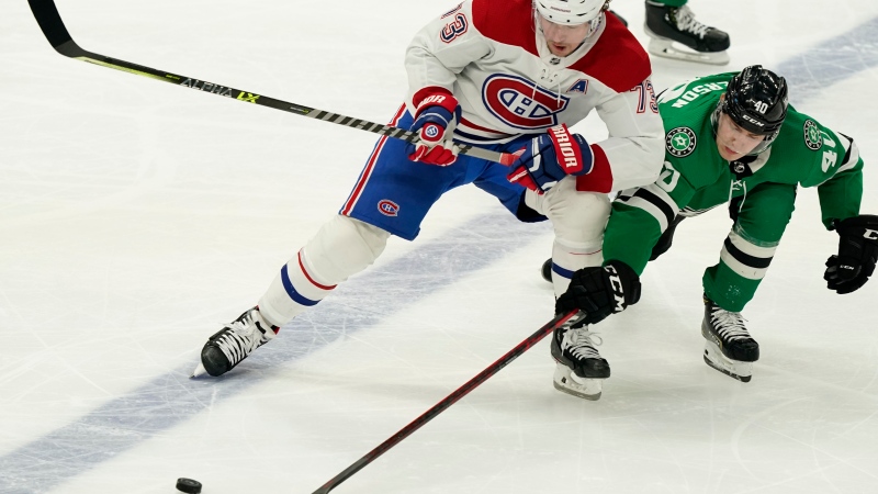 Montreal Canadiens center Cedric Paquette (13) and Dallas Stars center Jacob Peterson (40) skate for the puck during the third period of an NHL hockey game in Dallas, Tuesday, Jan. 18, 2022. The Canadiens won 5-3. (AP Photo/LM Otero) 