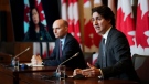 Prime Minister Justin Trudeau, right, and Minister of Health Jean-Yves Duclos take part in a press conference in Ottawa on Wednesday, Jan. 12, 2022. They are joined virtually by Minister of Small Business, Export Promotion and International Trade Mary Ng. THE CANADIAN PRESS/Sean Kilpatrick