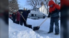 Students help clear snow from neighbourhood driveways and pathways on Jan 18 (Jamie Dowsett, CTV News)