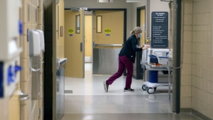 A nurse at Stormont Vail Health System pushes a hospital bed through hallways Wednesday, Nov. 18, 2020 in Topeka, Kan. (Evert Nelson/The Topeka Capital-Journal via AP)
