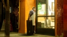 A restaurant worker closes up after a shift at take out restaurant in Toronto. THE CANADIAN PRESS/Chris Young
