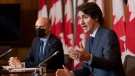 Health Minister Jean-Yves Duclos looks on as Prime Minister Justin Trudeau responds to a question during a news conference, Wednesday, Jan. 19, 2022 in Ottawa. THE CANADIAN PRESS/Adrian Wyld 