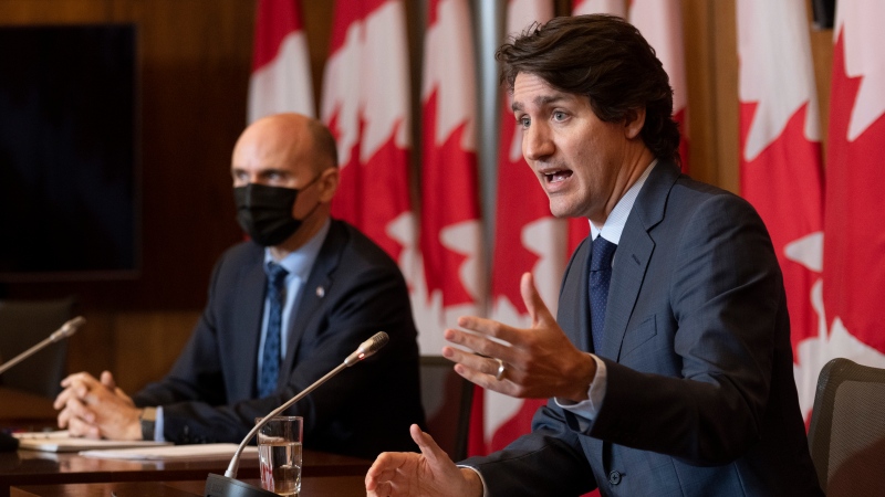 Health Minister Jean-Yves Duclos looks on as Prime Minister Justin Trudeau responds to a question during a news conference, Wednesday, Jan. 19, 2022 in Ottawa. THE CANADIAN PRESS/Adrian Wyld 