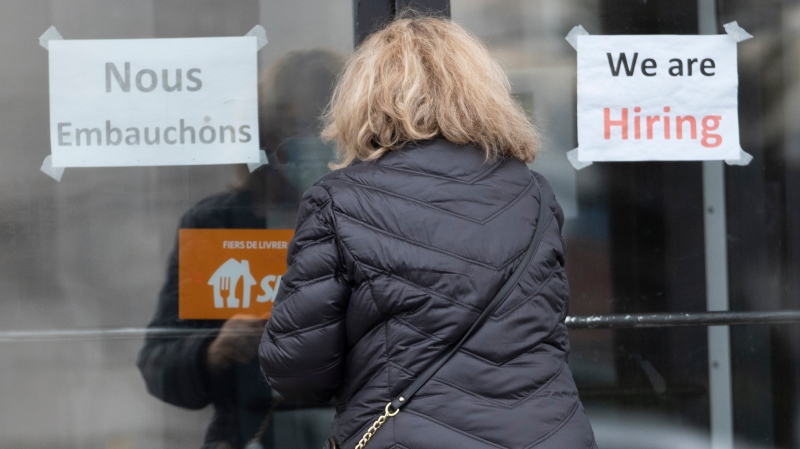 A customer enters a restaurant with help wanted signs Wednesday, November 17, 2021 in Laval, Que. as employers deal with the labour shortage. (THE CANADIAN PRESS / Ryan Remiorz)