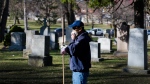 A worker walks through the Prospect Cemetery in Toronto on April 6, 2020. (THE CANADIAN PRESS/Nathan Denette)
