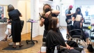 Amber Fairlie (centre), owner of 'The Manor' hair salon, cuts a customer's hair in Toronto, on Wednesday, June 30, 2021. THE CANADIAN PRESS/Chris Young