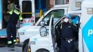 A paramedic adjusts his protective mask as he transfers a patient out of an ambulance to the emergency department at Michael Garron Hospital during the COVID-19 pandemic in Toronto on Monday, January 10, 2022. Ambulances have been in short supply in some regions through out the province of Ontario. THE CANADIAN PRESS/Nathan Denette