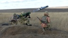 In this image taken from footage provided by the Ukrainian Defence Ministry Press Service, a Ukrainian soldiers use a launcher with U.S. Javelin missiles during military exercises in Donetsk region, Ukraine, Wednesday, Jan. 12, 2022. (Ukrainian Defense Ministry Press Service via AP)