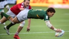 South Africa's Christie Grobbelaar dives for a try as Great Britain's Max McFarland tries to catch him during HSBC Canada Sevens gold medal rugby action, in Edmonton, Sunday, Sept. 26, 2021. (Jason Franson / THE CANADIAN PRESS)
