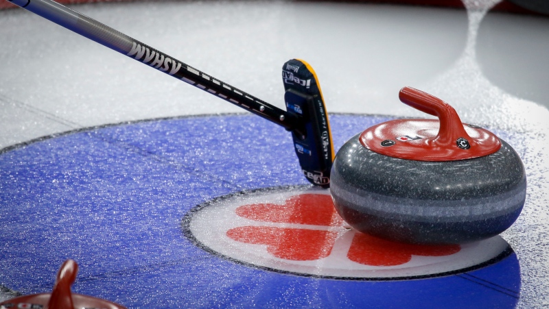 A players broom rests beside a rock directing a teammate where to aim for at the Scotties Tournament of Hearts in Calgary, Alta., Sunday, Feb. 21, 2021.THE CANADIAN PRESS/Jeff McIntosh 