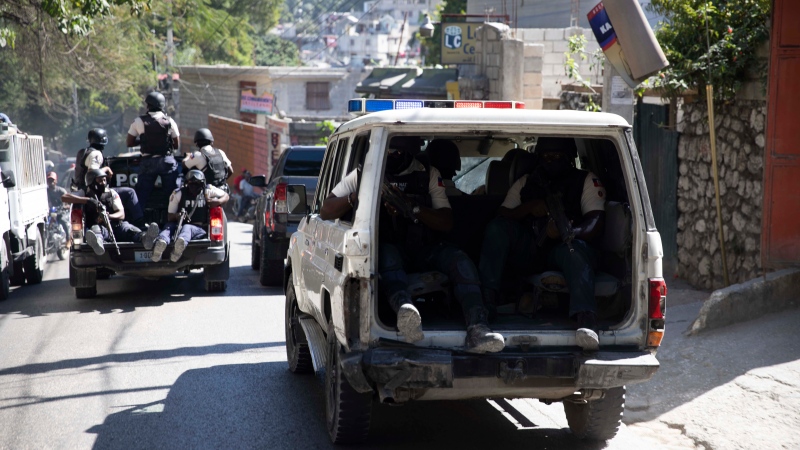 Police patrol after recovering the bodies of slain journalists in Port-au-Prince, Haiti, Friday, Jan. 7, 2022. (AP Photo/Odelyn Joseph) 