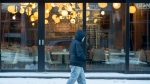 A man walks by an empty restaurant following a COVID-19 press briefing by Quebec Premier Francois Legault in Montreal, Thursday, January 20, 2022. The COVID-19 pandemic continues in Canada and around the world. THE CANADIAN PRESS/Graham Hughes 